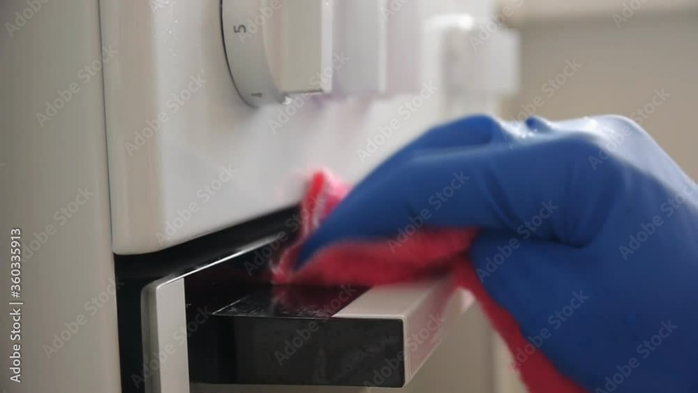 Cleaning The Electric Stove Close-up In The Kitchen Cleaning The Electric Stove Close-up In The Kitchen