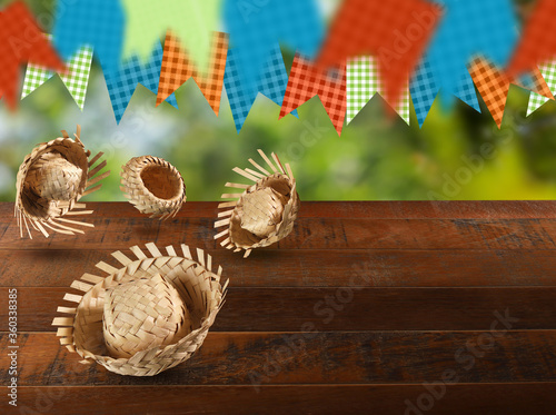 Group of hats from the Festa Junina, a typical Brazilian party on a green and wood background. Selective focus