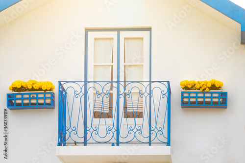 Colored window and balcony in typical small wooden house with colorful stripes in Costa Nova, Aveiro, Portugal. Detail of the house in famous resort Costa Nova