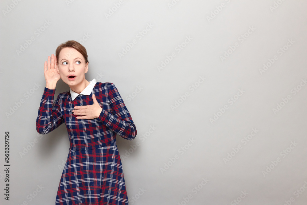 Portrait of curious girl placing hand near ear and eavesdropping Portrait of curious girl placing hand near ear and eavesdropping