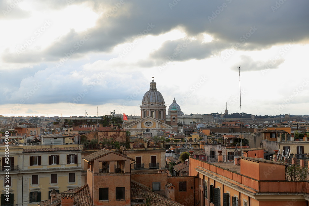 View of Rome at dusk with dark clouds, Italy. Landscape view, of the Cupolas Church. Italy