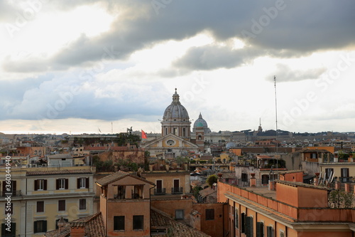 View of Rome at dusk with dark clouds, Italy. Landscape view, of the Cupolas Church. Italy