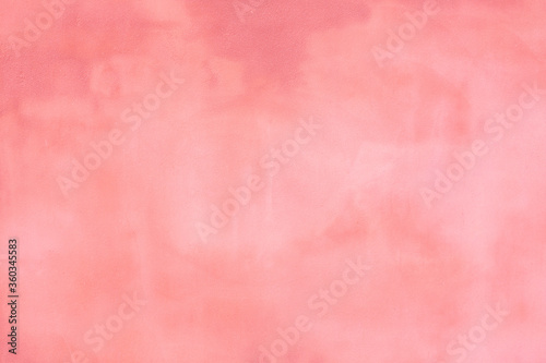 Rustic pink blush concrete cement wall with darker and lighter areas to use as a background or banner