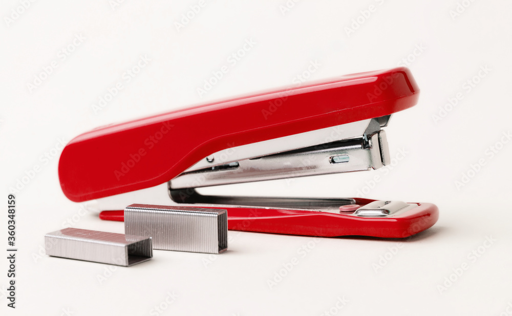 Red stapler on a white background. Red stapler on a white background.