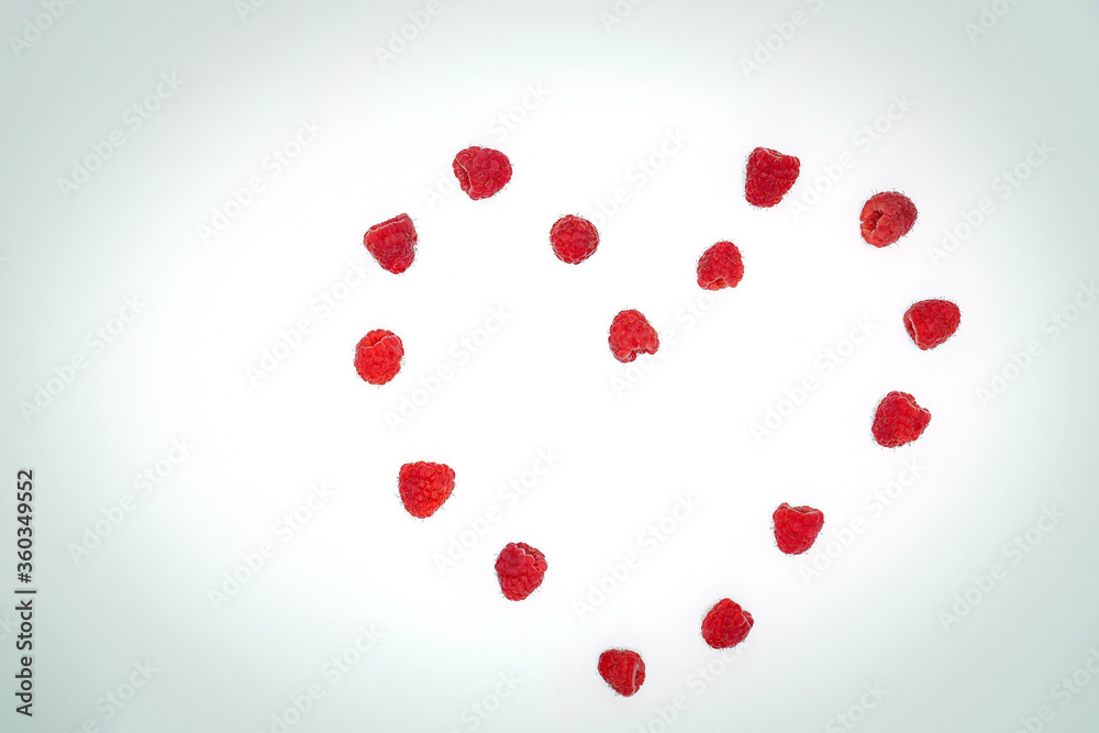 Close-up view of fresh raspberries making a heart shape