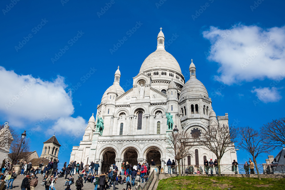 Tourists visiting the Sacre Coeur Basilica at the Montmartre hill in Paris France Tourists visiting the Sacre Coeur Basilica at the Montmartre hill in Paris France