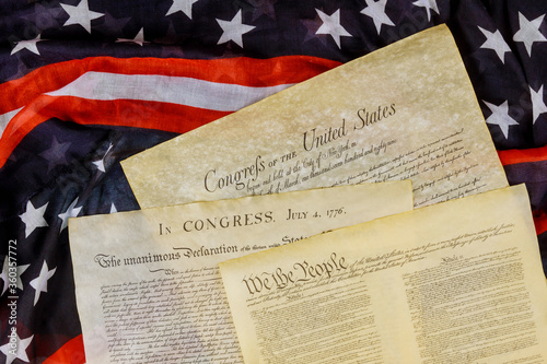 Close up of a replica of U.S. document of American constitution We the people with USA Flag. photo