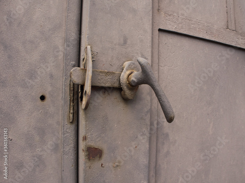 Old door latch rusted grey door