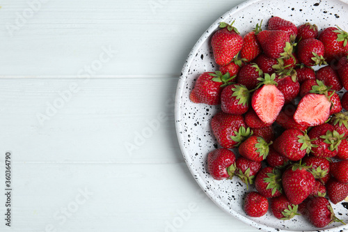Delicious ripe strawberries on white wooden table, top view. Space for text