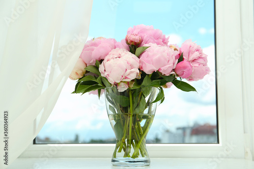 Fototapeta Naklejka Na Ścianę i Meble -  Bouquet of beautiful peonies in vase on window sill