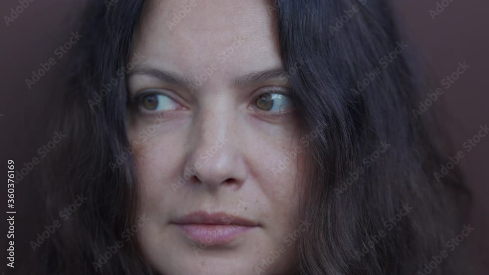 Adult woman portrait on brown background. Close up of brunette woman face. Attractive woman thinking, looking at camera. Female person with long hair beautiful brown eyes. Adult woman portrait on brown background. Close up of brunette woman face. Attractive woman thinking, looking at camera. Female person with long hair beautiful brown eyes.