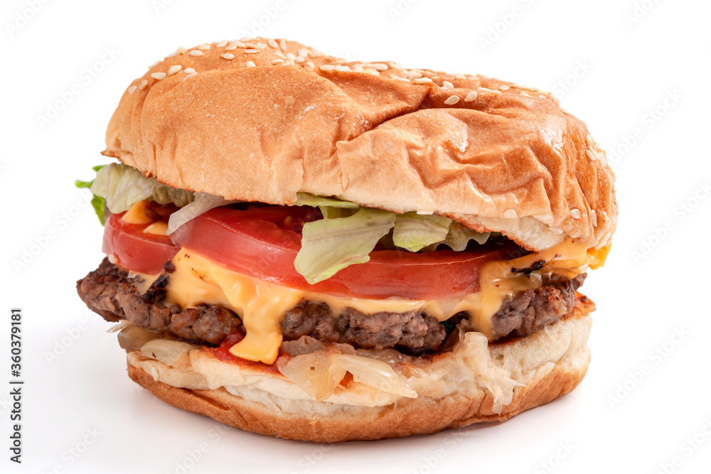 Foods high in cholesterol and saturated fat, fast food and unhealthy diet concept with low key picture of delicious American cheeseburger isolated on white background with clipping path cutout