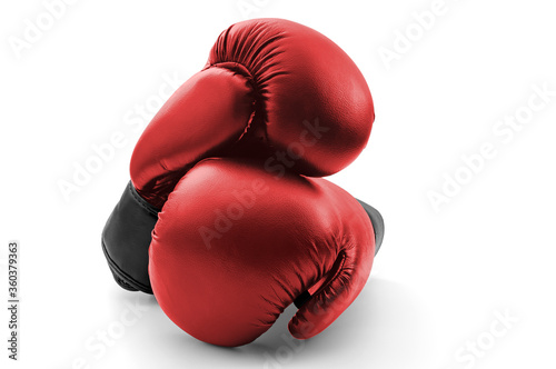 Competitive sports, fist protection and martial arts concept with photograph of two red boxing gloves with one glove on top of the other isolated on white background with clipping path cutout © Victor Moussa