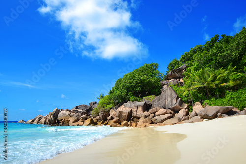 Petite Anse beach with big granite stones in La Digue Island, Seychelles. Tropical landscape with sunny sky.