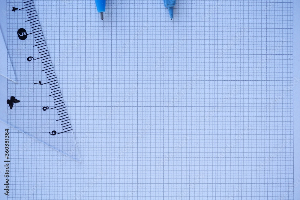 Close-up of Architect engineer drawing plan on blueprint with architect equipment. Architect Desk Top View with Drawing Plan, Drawing Compass White Background Copy Space Close-up of Architect engineer drawing plan on blueprint with architect equipment. Architect Desk Top View with Drawing Plan, Drawing Compass White Background Copy Space