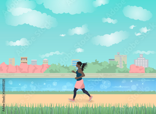 Running for fitness. Side view of a woman with a ponytail on a running trail with grass overlooking a beautiful lake. Clear blue sky with clouds. Far away is buildings and green trees. 