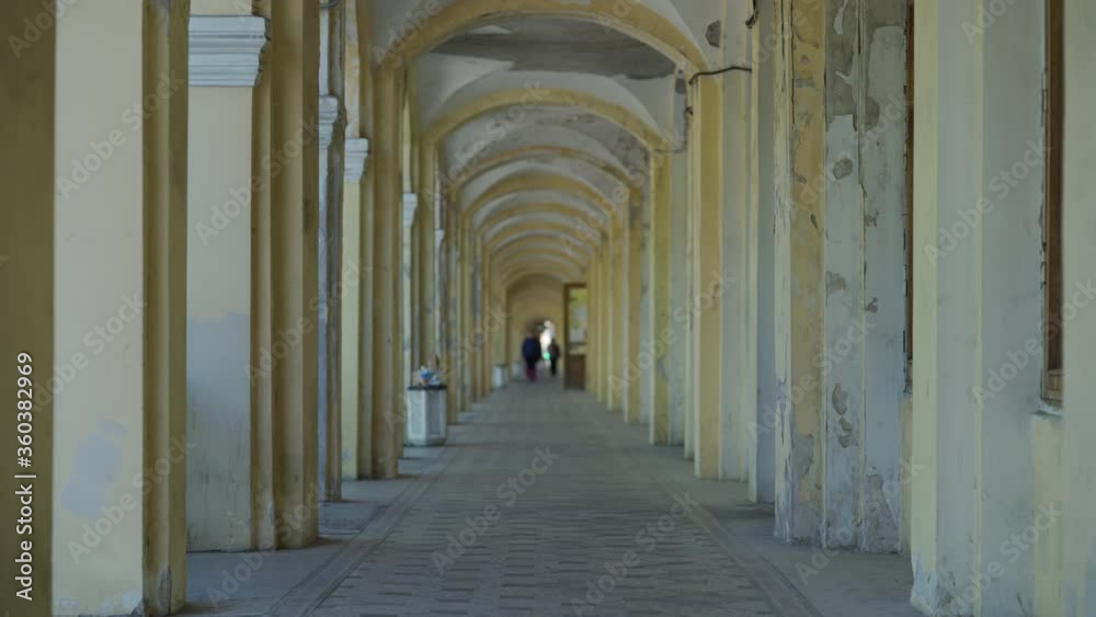People walking on stone terrace arched corridor of Gostiny dvor in Pushkin town, Saint Petersburg, Russia. People walking on stone terrace arched corridor of Gostiny dvor in Pushkin town, Saint Petersburg, Russia.
