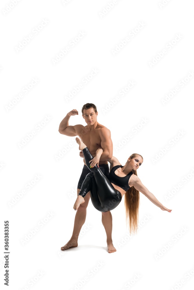Young couple doing acrobatics isolated shot