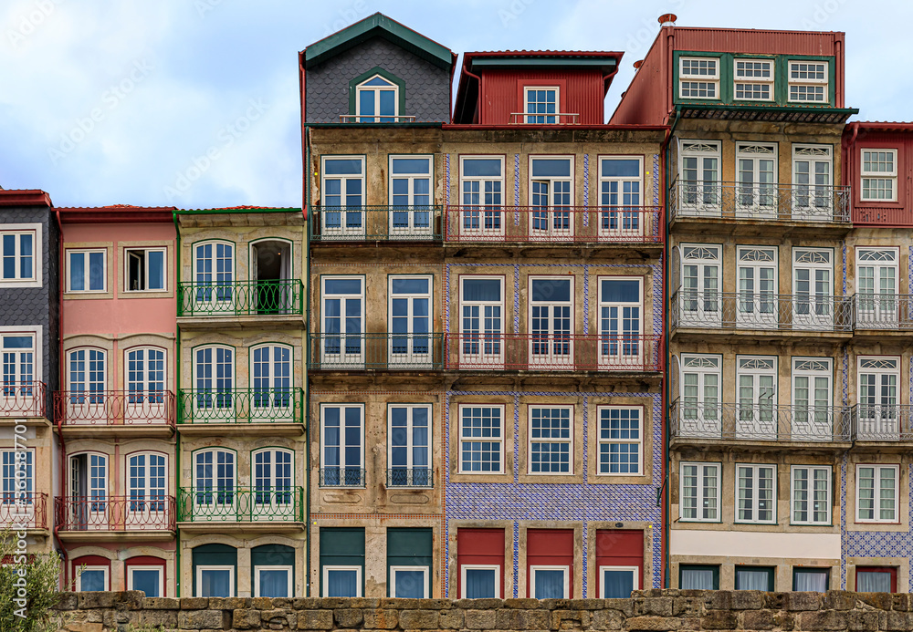 Traditional house facades decorated with Portuguese azulejo tiles in the famous Ribeira neighborhood in Porto, Portugal