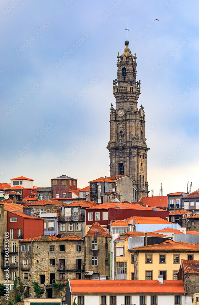 Baroque Torre dos Clerigos church bell tower viewed over the terracotta roofs of the old town of Porto, Portugal