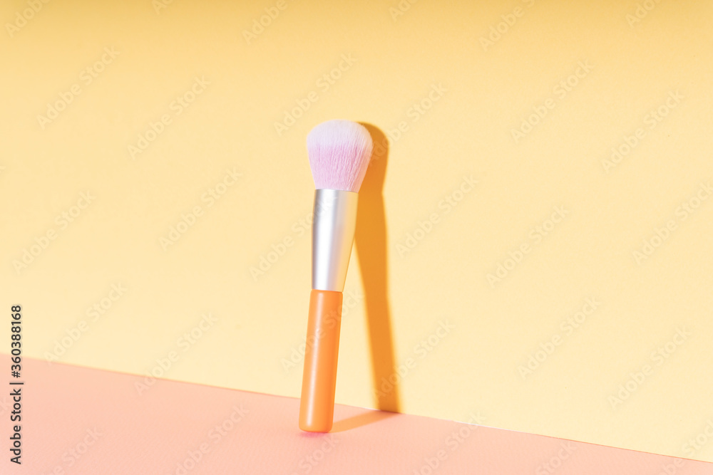 Make up brush cosmetic essential on bright yellow background. Make up brush cosmetic essential on bright yellow background.