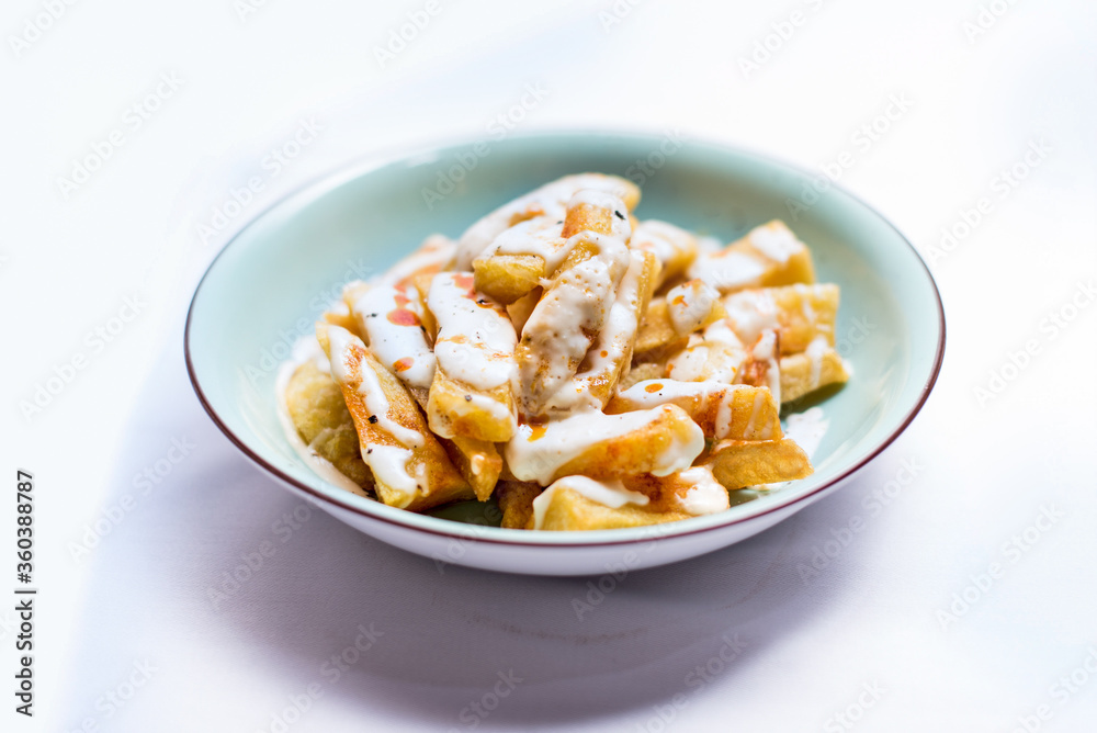 Potato dish with sauce on a white background Potato dish with sauce on a white background