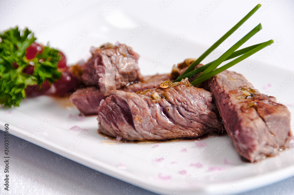 A plate of meat on a white background