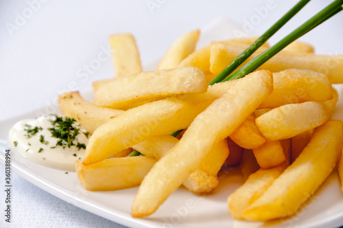A plate of french fries on a white background