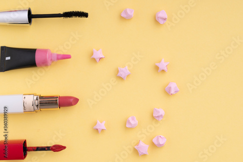Top view. Flat lay. Cosmetic make up tools set collection over bright yellow background.