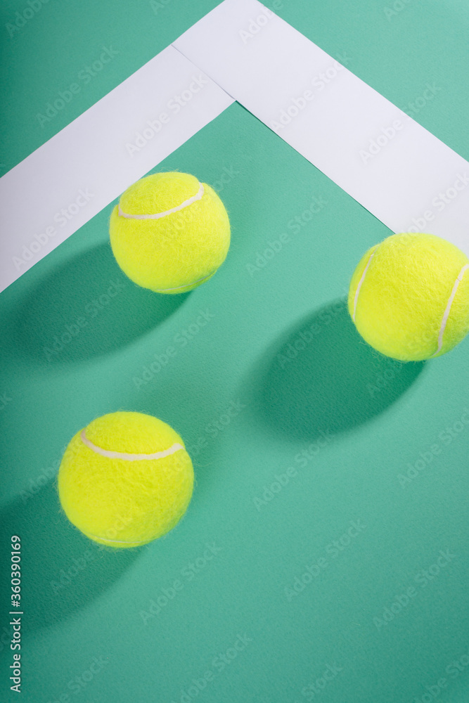 Top view - Three tennis balls on green court. Sport concept.
