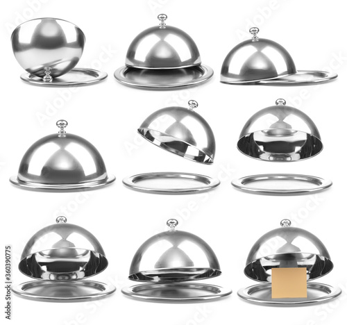 Trays with cloches on white background photo