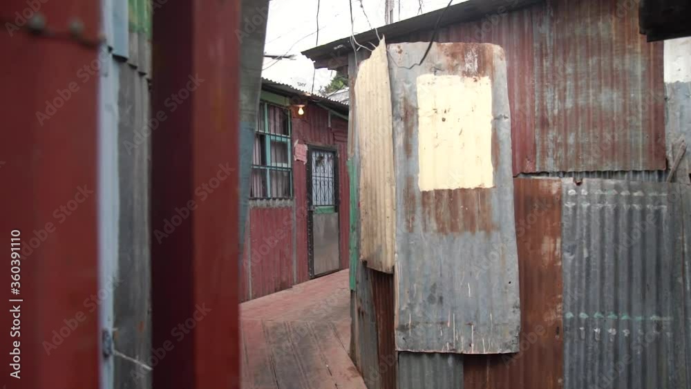 Cinematic shot of interior slum settlement at day in slow motion in Costa Rica