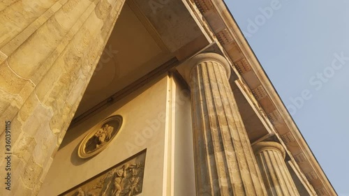 Cinematic shot of Brandenburg Gate concrete columns in Berlin during sunset photo