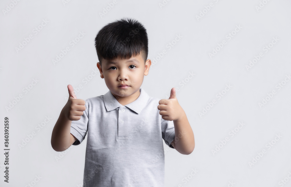 Cute little child having fun. studio portrait on gray background Cute little child having fun. studio portrait on gray background