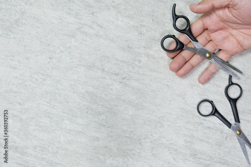 hand holding scissors