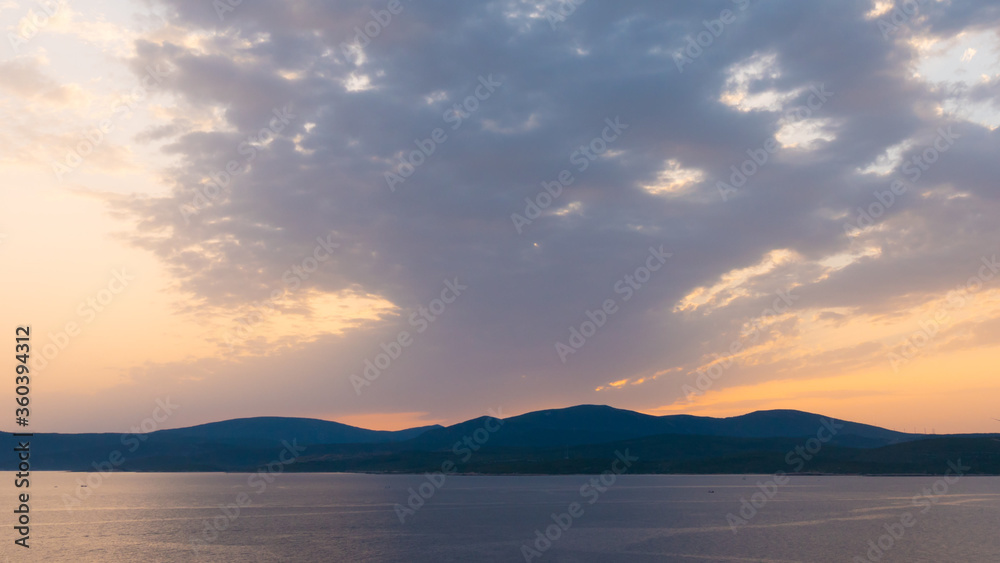 Romantic colorful sunset over the sea. Sun go down, blue and orange clouds flow in the sky time lapse. Romantic colorful sunset over the sea. Sun go down, blue and orange clouds flow in the sky time lapse.