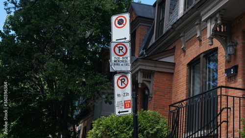 Montreal, QC/ Canada - 6/24/2020: Parking challenge in downtown. No Parking signs: middle (Wednesdays from 7:30 to 8:30 AM, from Apr 1st to Dec 1st), bottom (9:00 AM to 11:00 PM except for sector 13)