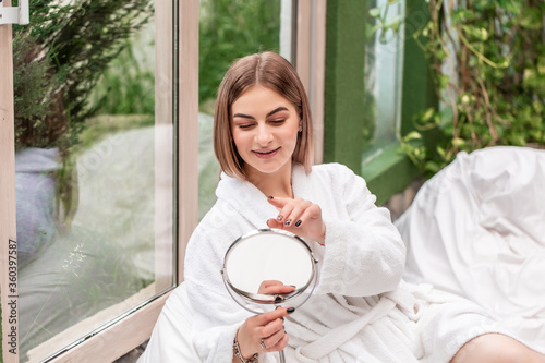 Fotografie mothers day Young beautiful woman looking in the mirror