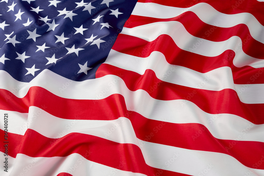 Obraz premium Close up of ruffled American flag. Satin texture curved flag of USA. Memorial Day or 4th of July. Banner, freedom concept