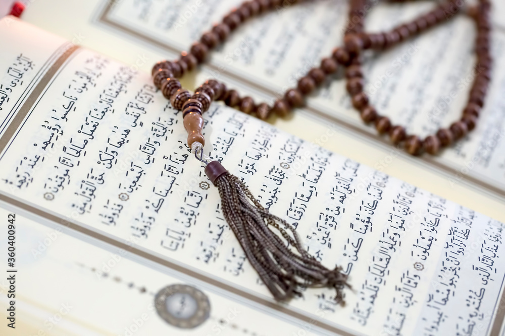 Islamic Book Koran with rosary on background Islamic Book Koran with rosary on background