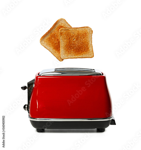 Two toasts jumping out of red toaster against white background