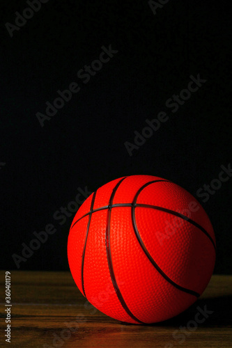 Basketball on a dark wooden floor, Dark background. Selective focus.