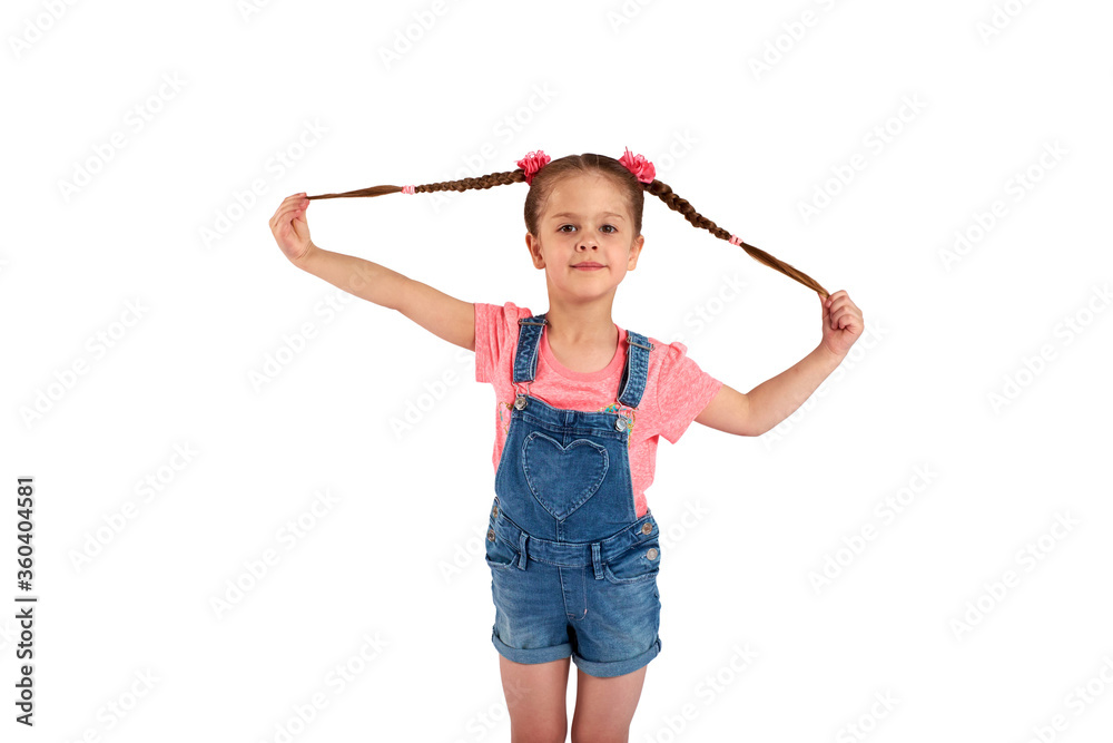 Cute small girl smailing and pulling her hair in the air, isolated on white background Cute small girl smailing and pulling her hair in the air, isolated on white background