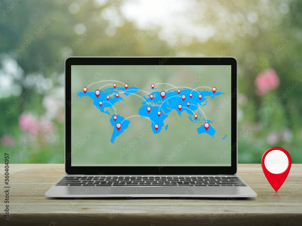 Map pin location button with connection line and world map on modern laptop computer on wooden table over blur pink flower and tree in garden, Map pointer navigation online concept, Elements of this i Map pin location button with connection line and world map on modern laptop computer on wooden table over blur pink flower and tree in garden, Map pointer navigation online concept, Elements of this i