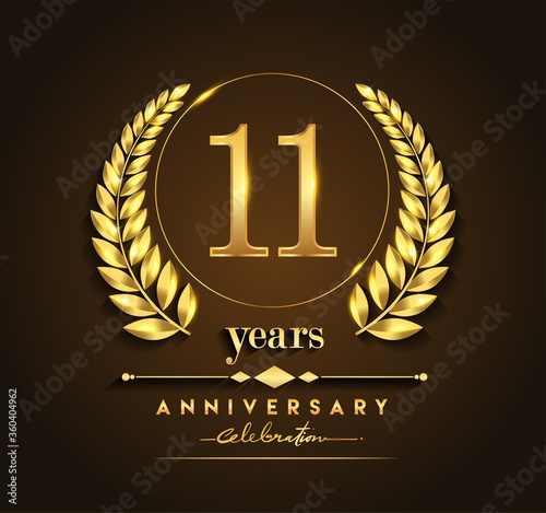 11th gold anniversary celebration logo with golden color and laurel wreath vector design.