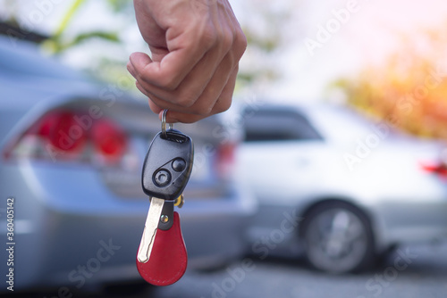 The car salesman and the key to the new owner.