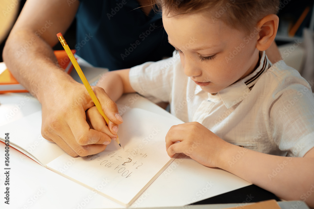 Little boy writing something in his notebook Little boy writing something in his notebook
