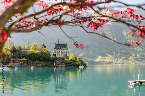 view of Schloss Seeburg, Iseltwald in turquoise Lake Brienz