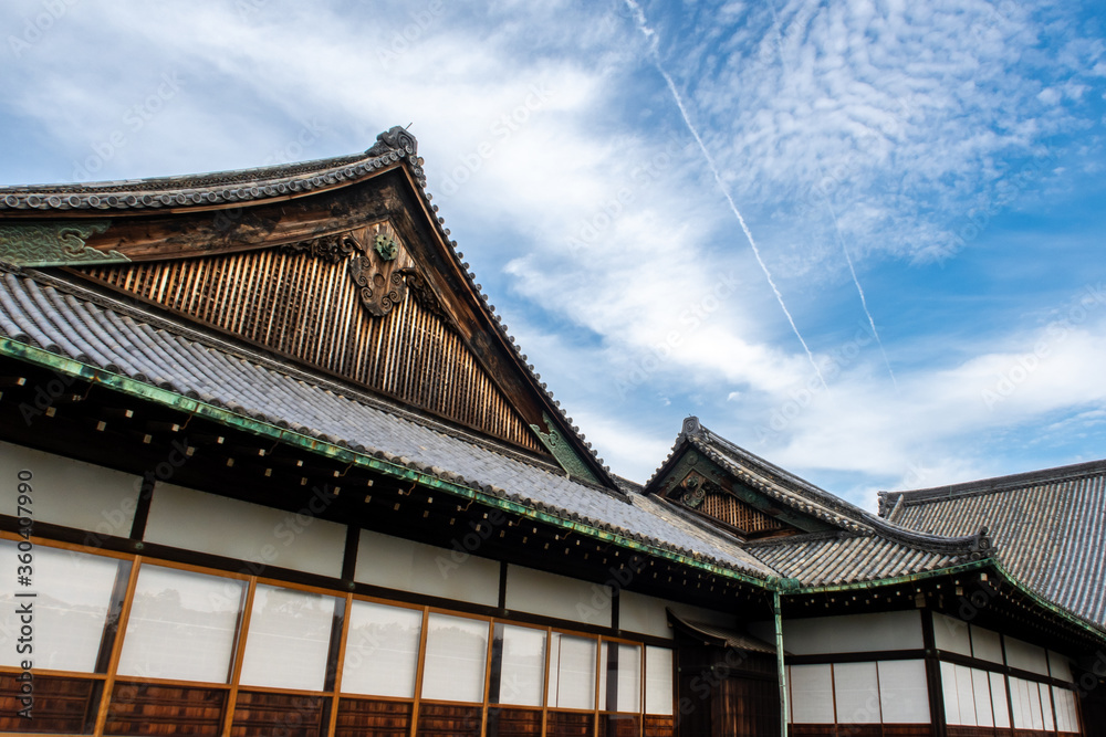 Nijo Castle ancient carved wooden roofs with blue sky and aircraft contrails in the background, Kyoto, Japan.
Nijo Castle ancient carved wooden roofs with blue sky and aircraft contrails in the background, Kyoto, Japan.