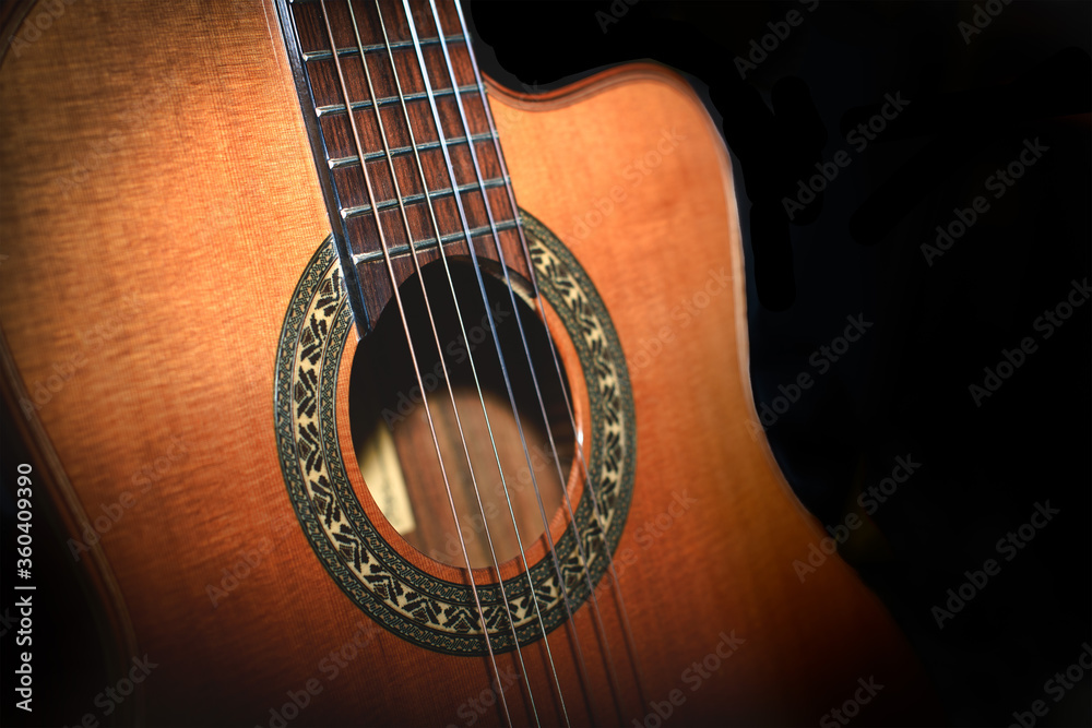 Classical guitar detail on black background Classical guitar detail on black background